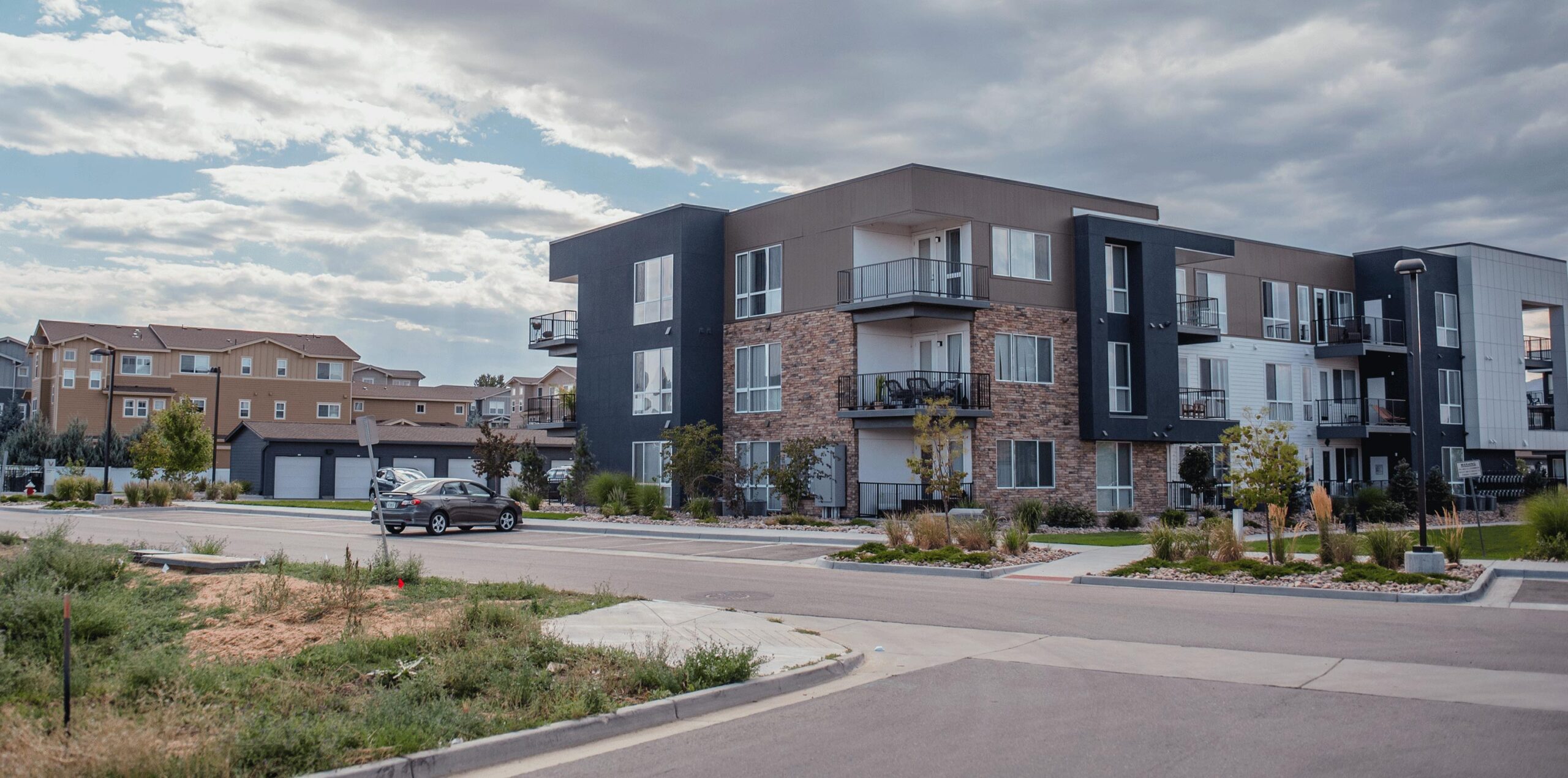 Wide shot of the exterior of a multifamily apartment complex