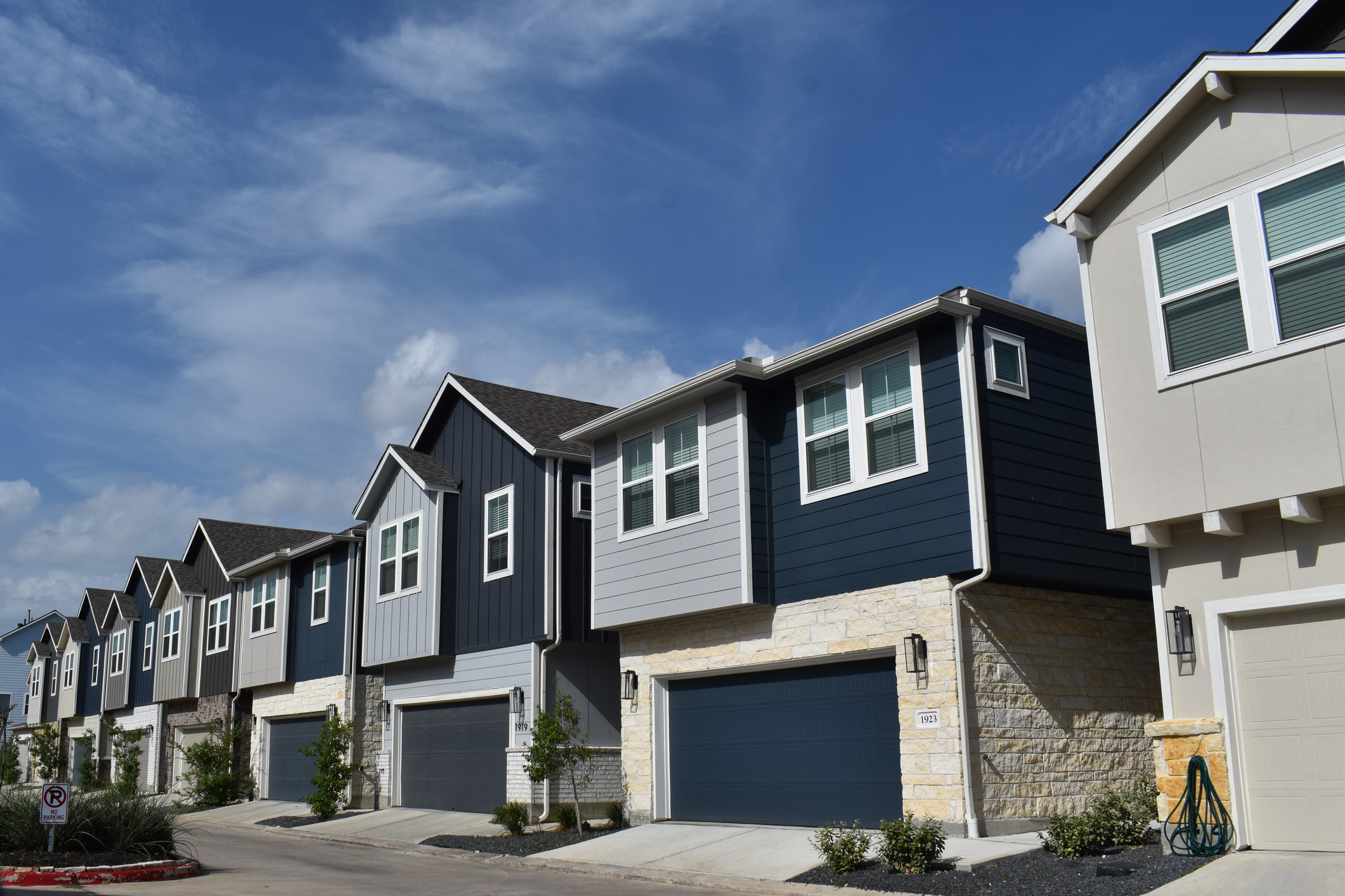 Wide shot of row of double story blue modern townhomes
