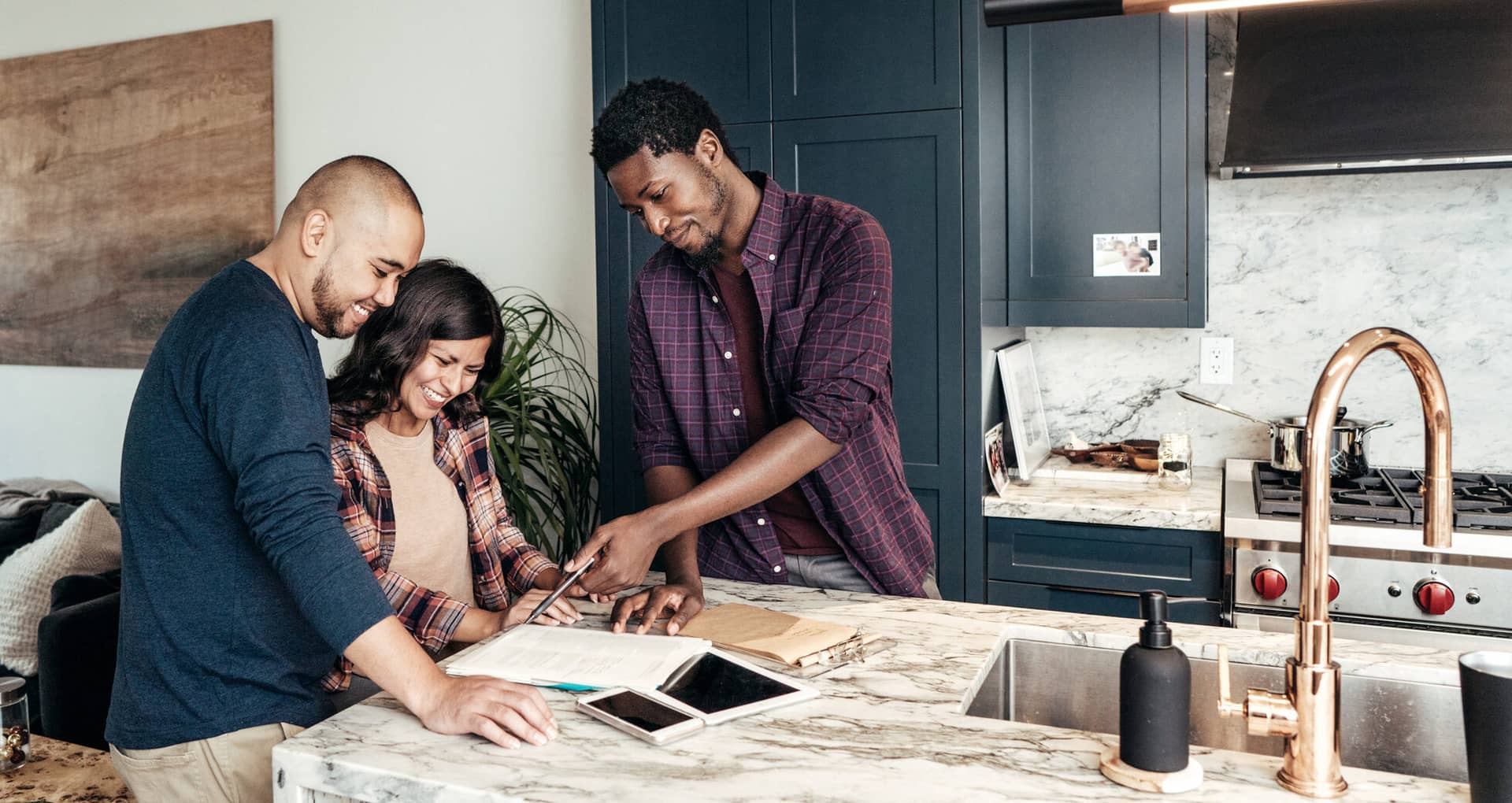 Multiracial family getting home advising while standing in a modern kitchen