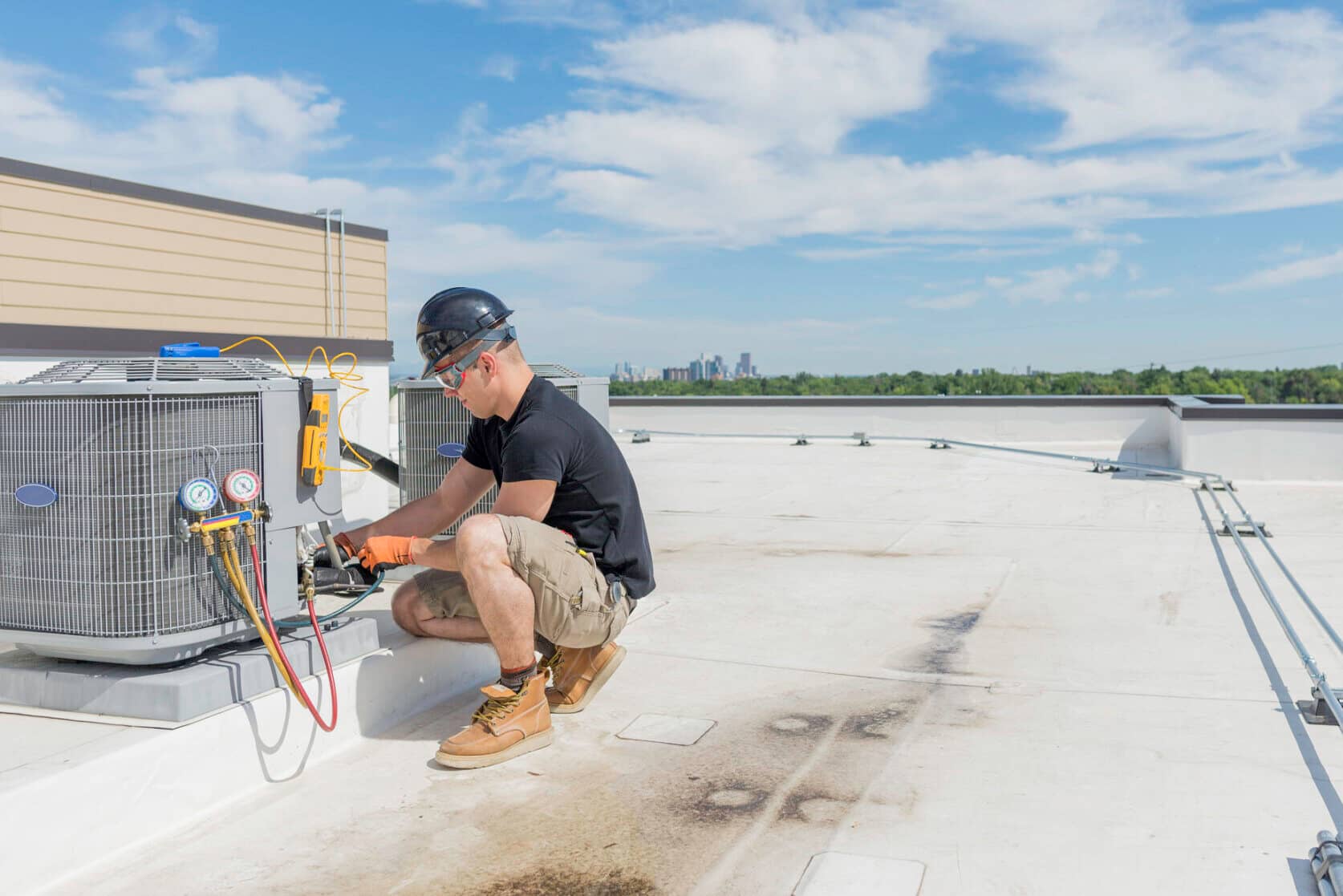 Hvac technician working on an air conditioning unit with lots of open space