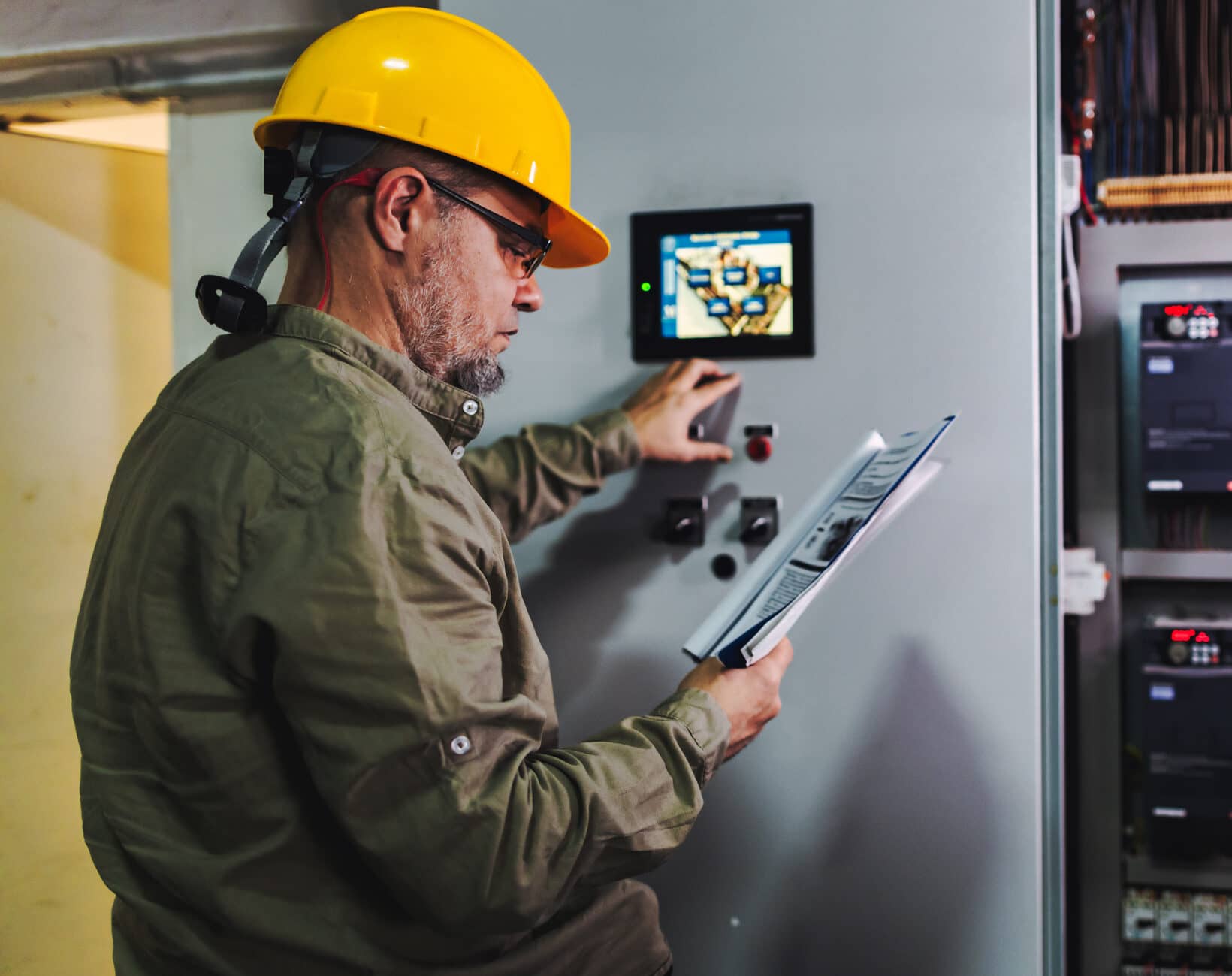 Engineer working on computer to maintain heating and cooling systems.