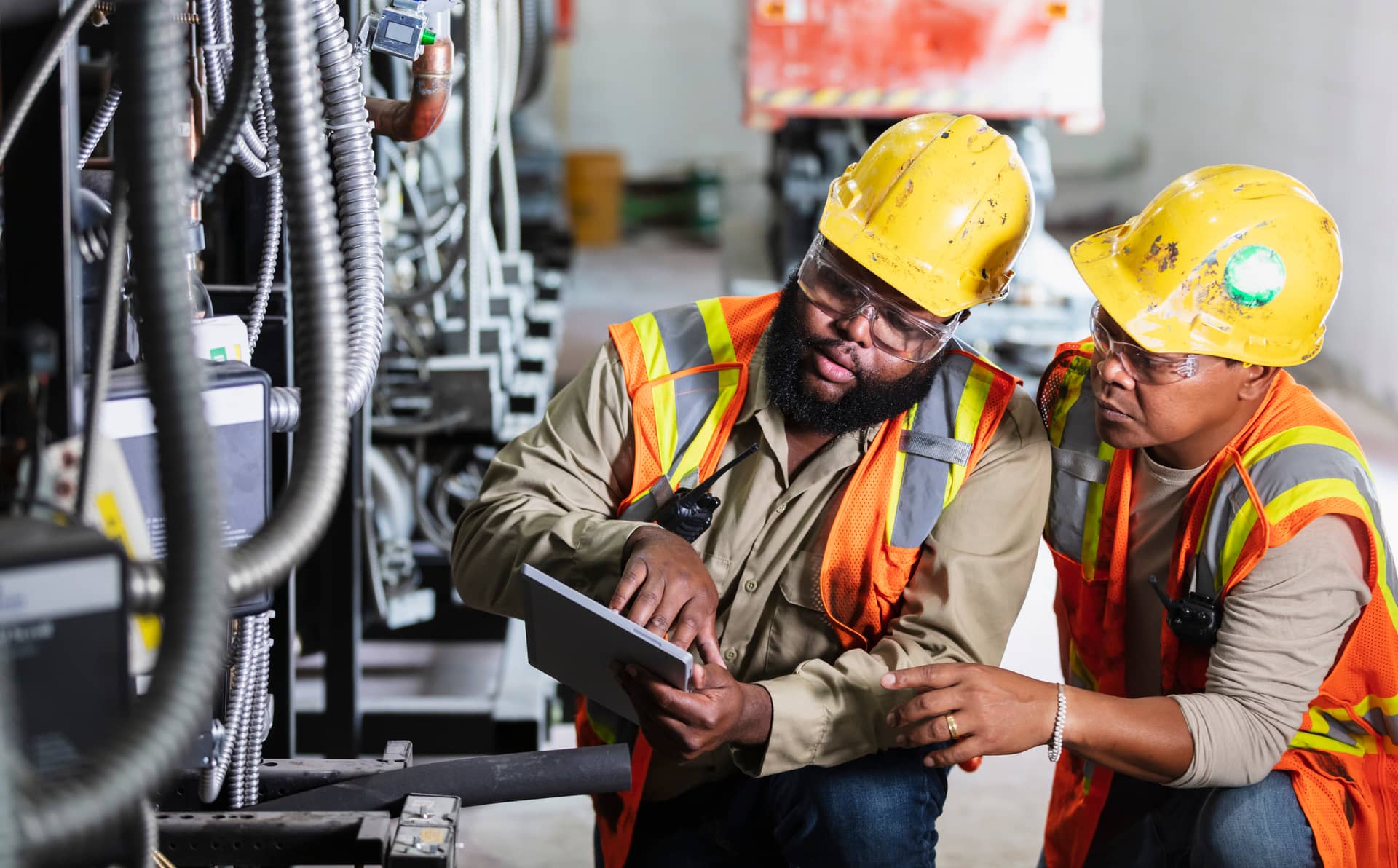Two workers inspecting industrial refrigeration equipment