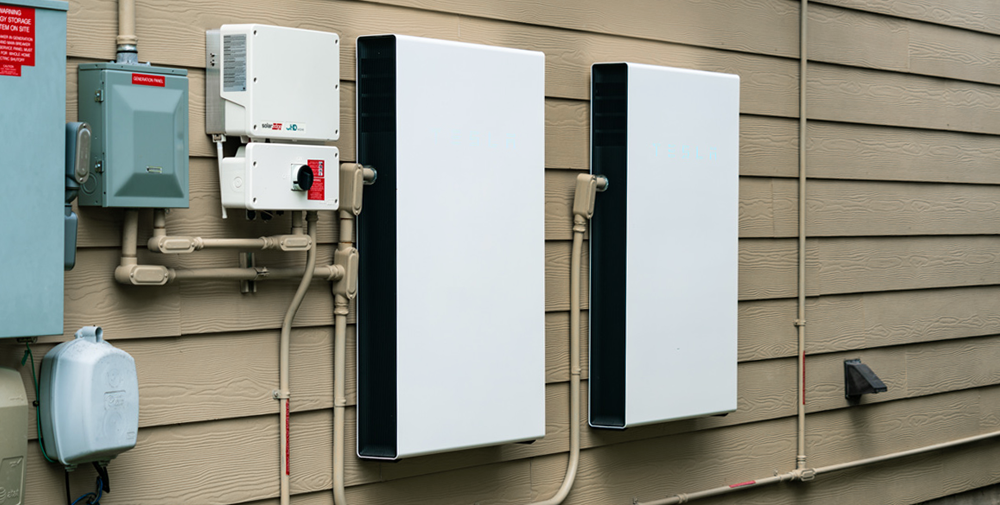 Two battery storage units installed on a side of a home