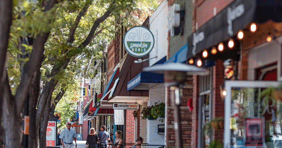 Street lined up with businesses and people walking.
