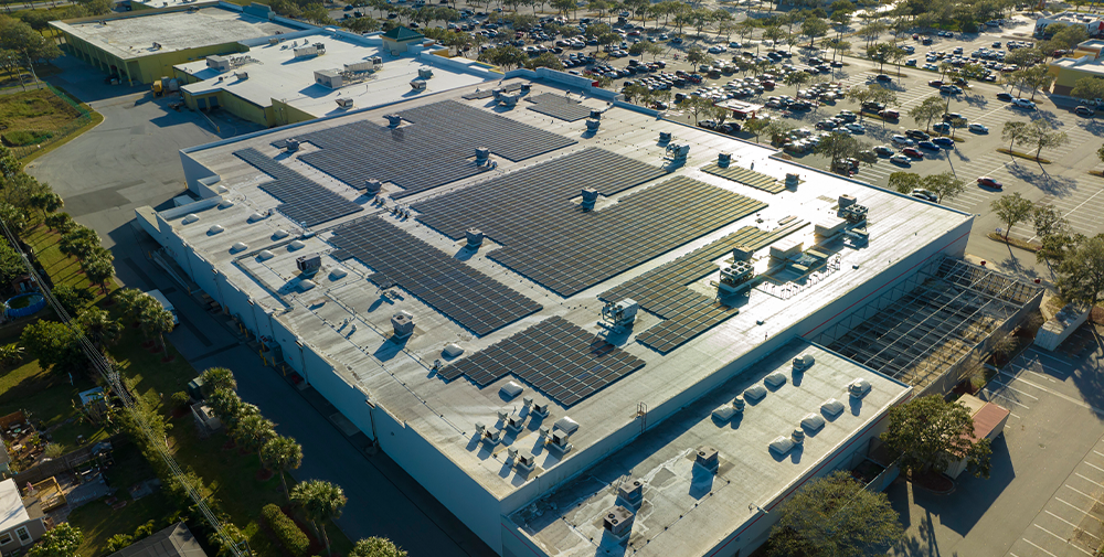 Aerial photo of solar panels on top of a warehouse