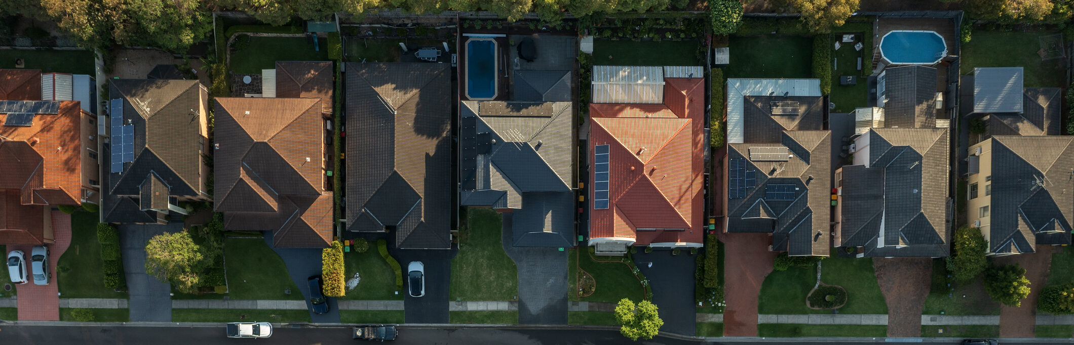 Early morning top down aerial view of a neighbourhood street lined with upmarket houses