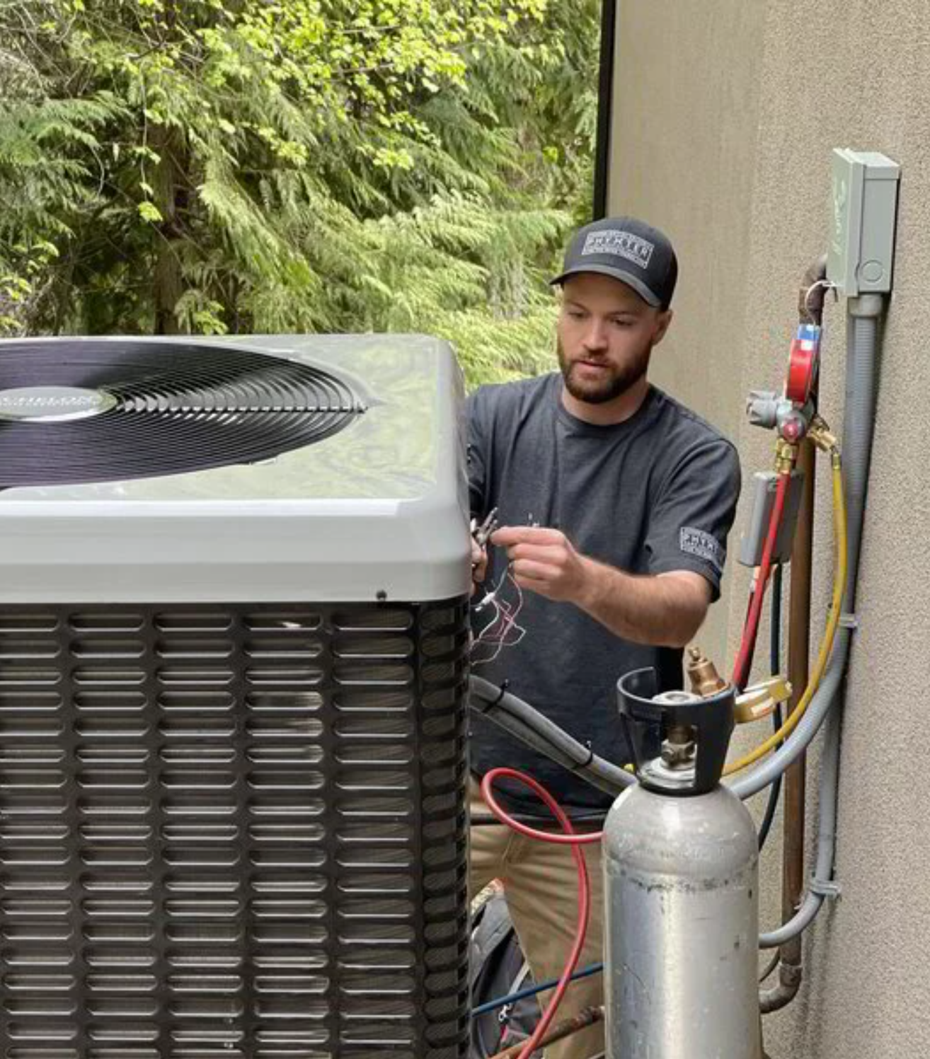 Man installing AC unit outside of home