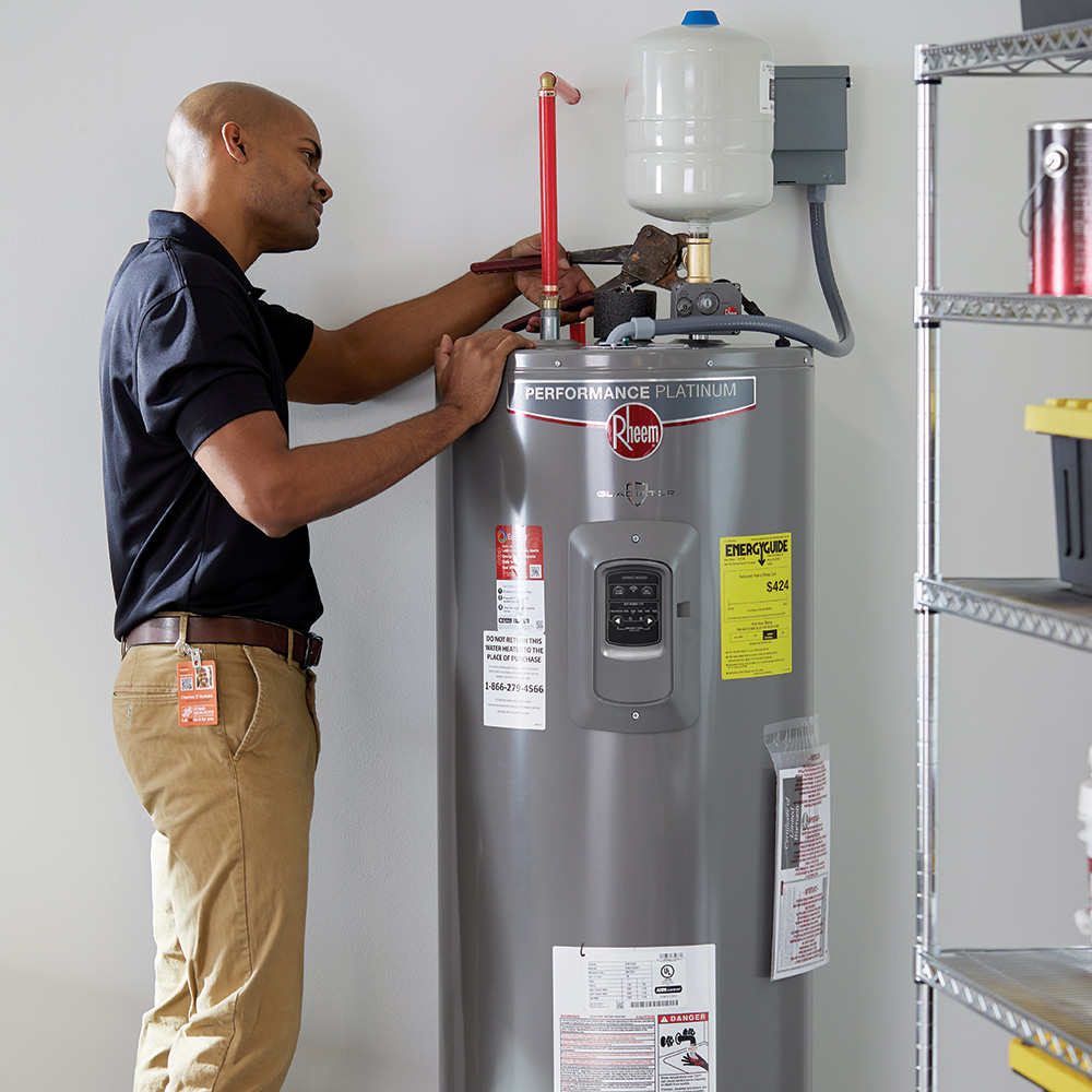 Man installing heat pump water heater