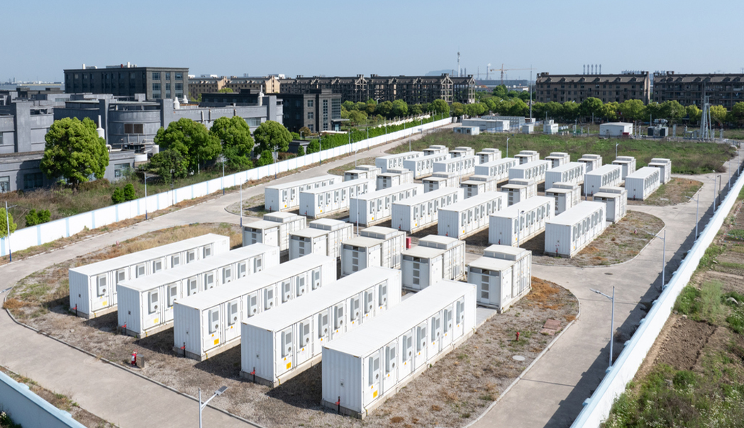 large group of white buildings sitting on top of a field