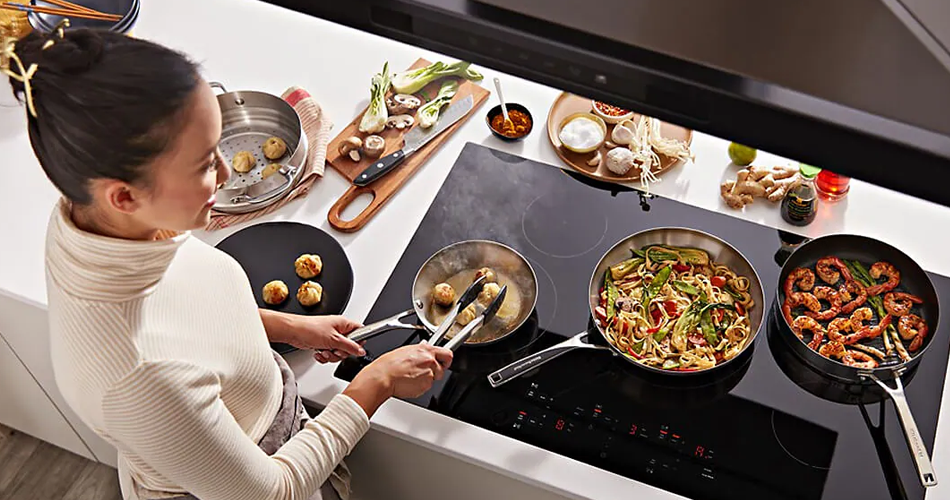 Woman cooking with an induction cooktop