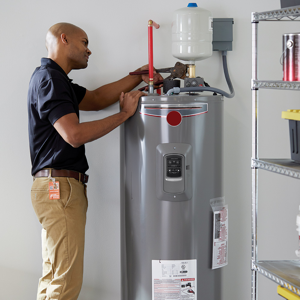 Man installing heat pump water heater